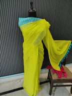 Yellow saree with blue border on a black surface