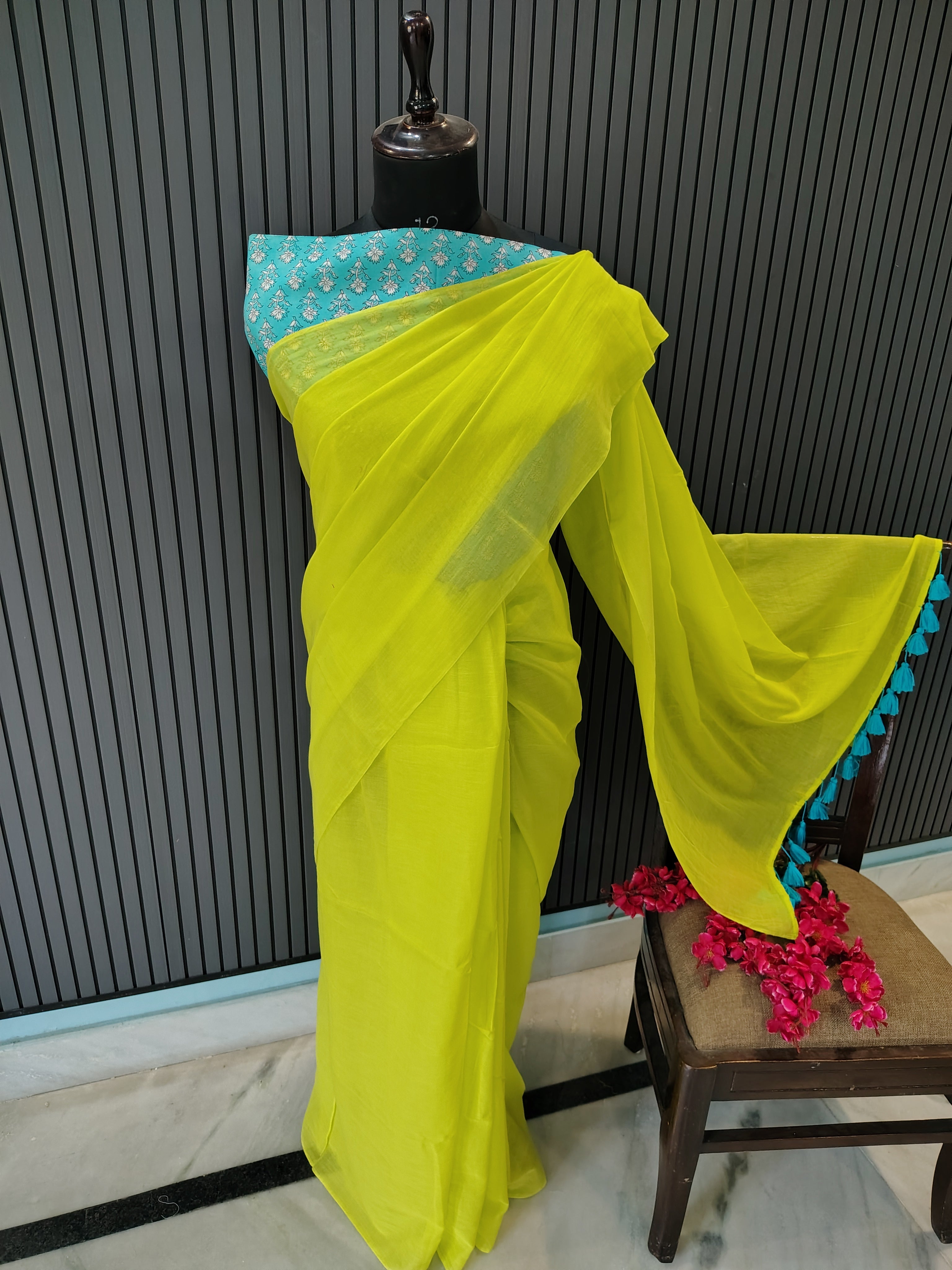Yellow saree with blue border on a black surface